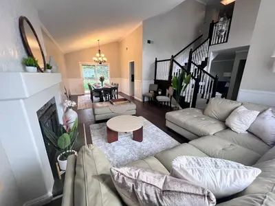 a living room with a couch and a table at Bright & Spacious 5BR Modern Vacation Home - Near Disneyland & Beaches in Orange