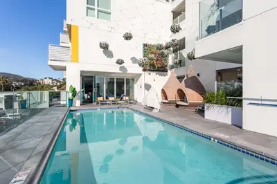 a swimming pool in front of a building at Boutique Mini 1 BD Residence in Los Angeles