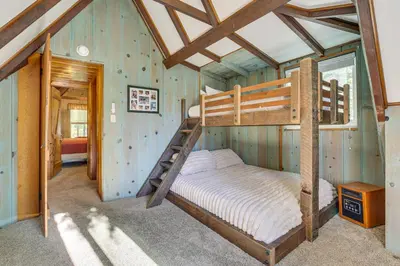 a bedroom with two bunk beds in a house at Private Dock on Lake Arrowhead! Cozy Mtn Cabin in Lake Arrowhead
