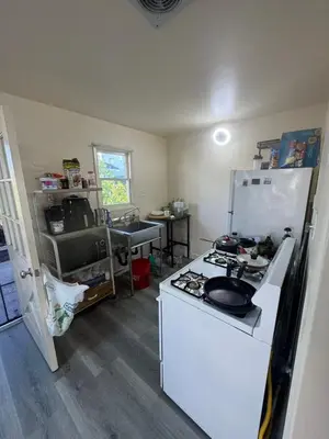 a kitchen with a stove and a white refrigerator at Long Beach vocation home in Long Beach