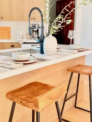 a kitchen counter with a wooden stool in a kitchen at The Chapel - Luxury Historic Ojai Villa in Ojai