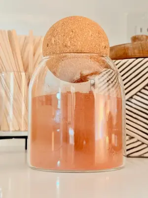 a glass jar filled with liquid on a table at The Chapel - Luxury Historic Ojai Villa in Ojai