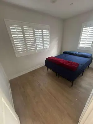 a bedroom with two blue beds and two windows at Normandie Good Vibes Only in Los Angeles