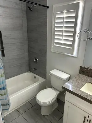 a bathroom with a toilet and a tub and a sink at Normandie Good Vibes Only in Los Angeles
