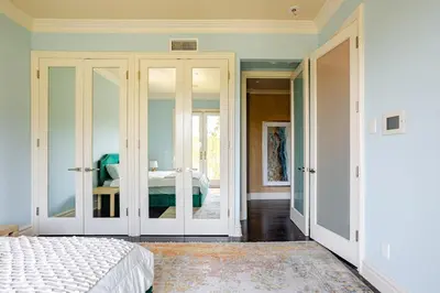a bedroom with a bed and sliding glass doors at Mansion in the hills near Universal Studios!