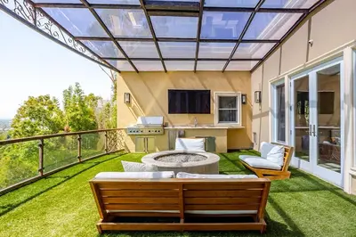 a patio with a couch and a table at Mansion in the hills near Universal Studios!