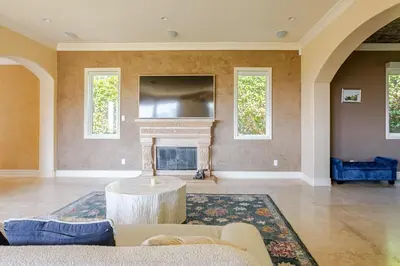 a living room with a couch and a fireplace at Mansion in the hills near Universal Studios!