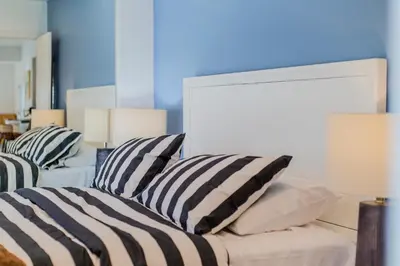 a living room with two striped pillows on a couch at Minimalist Serene Home near Rose Bowl Stadium in Pasadena