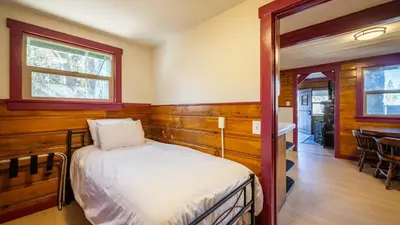 a bedroom with a bed and a window and a table at Arkouda Stays in Big Bear Lake