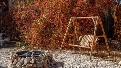 a swing and a chair next to a fire pit at Arkouda Stays in Big Bear Lake