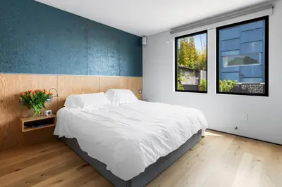 a bedroom with a large bed and a window at Brooks Beach House Your Venice Escape in Los Angeles