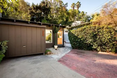 a house with a garage and a driveway at Laurel Canyon Hideaway Fireplace and Sauna in Los Angeles