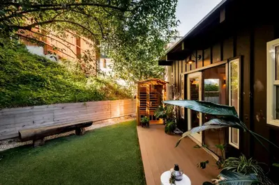 a backyard with a bench and a building at Laurel Canyon Hideaway Fireplace and Sauna in Los Angeles