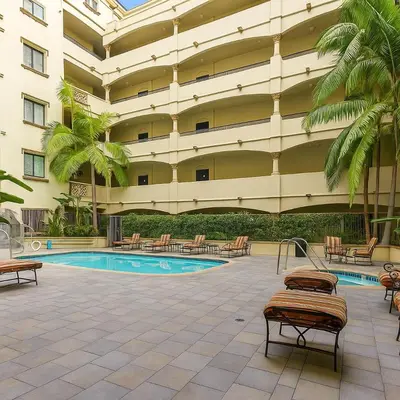 a large building with a swimming pool in a courtyard at Modern 1Bed in Koreatown- Pool, Sauna & Free Parking in Los Angeles