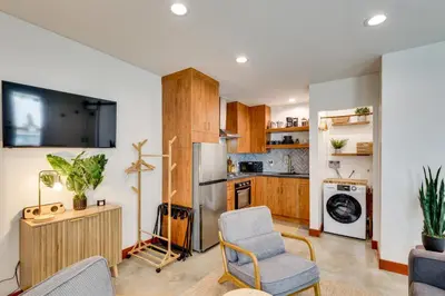 a kitchen with wooden cabinets and a refrigerator at 3 Mi to Old Pasadena Cozy Couples Studio with Pool in Pasadena