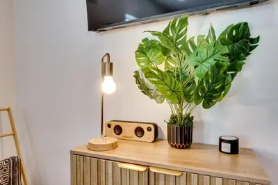 a table with a speaker and a plant on it at 3 Mi to Old Pasadena Cozy Couples Studio with Pool in Pasadena