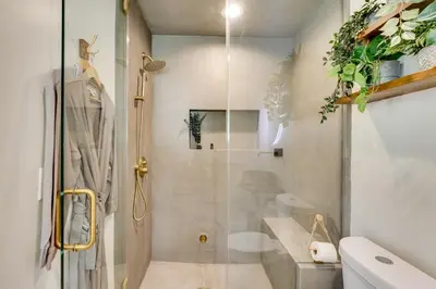 a bathroom with a shower with a glass door at 3 Mi to Old Pasadena Cozy Couples Studio with Pool in Pasadena