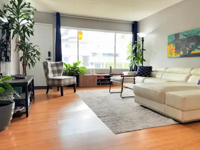 a living room with a white couch and some plants at Proper Stays at Melrose - West Hollywood Premium E suite in Los Angeles