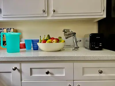a bowl of fruit on a counter in a kitchen at Proper Stays at Melrose - West Hollywood Premium E suite in Los Angeles