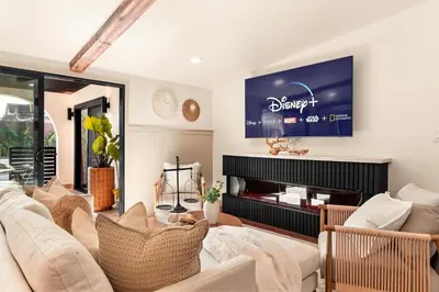 a living room with a couch and a fireplace at Exclusive Disney Resort- Private Pool & Luxe Stay in Anaheim