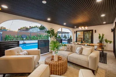 a living room with two couches and a pool at Exclusive Disney Resort- Private Pool & Luxe Stay in Anaheim