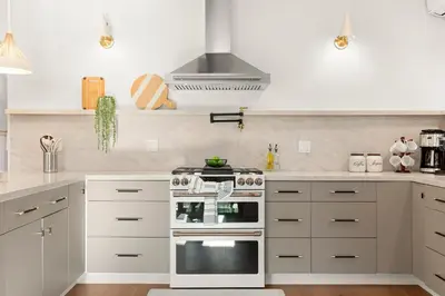 a kitchen with white cabinets and a stove at Exclusive Disney Resort- Private Pool & Luxe Stay in Anaheim
