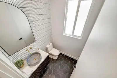 a bathroom with a sink and a toilet and a mirror at Modern 3BR with King Bed, Gated Pool and BBQ Oasis in West Valley Area Heliport