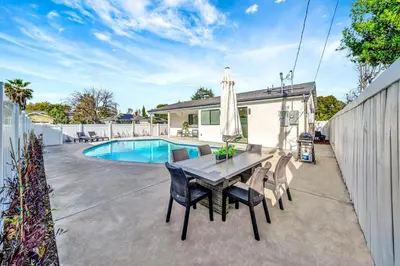 a patio with a table and chairs and a pool at Modern 3BR with King Bed, Gated Pool and BBQ Oasis in West Valley Area Heliport