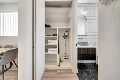 a bathroom with white shelves and a sink at Modern 3BR with King Bed, Gated Pool and BBQ Oasis in West Valley Area Heliport