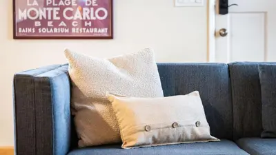 a blue couch with a pillow in a living room at Sunny Venice Beach Home with Open Living Walkability to Abbot Kinney Venice Drift by AvantStay in Los Angeles