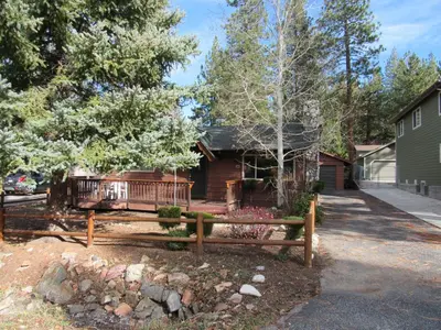 a wooden bench in front of a house at M & M Sweet Retreat in Big Bear Lake