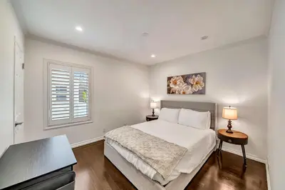 a white bedroom with a bed and a window at Charming 3BR with Ping-Pong and Spa!