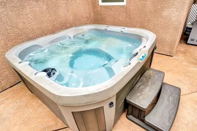 a jacuzzi tub with a dog in it at Charming 3BR with Ping-Pong and Spa!