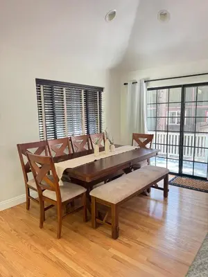 a dining room with a table and chairs and windows at Woodsy Chic Family-Friendly Spacious Getaway in Lake Arrowhead