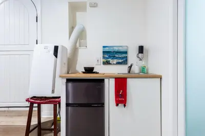 a kitchen with a counter and a refrigerator at Hillside Home with Outdoor Oasis and Pool in Sherman Oaks