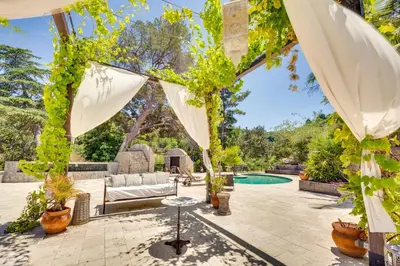 an outdoor patio with a pergola and a swimming pool at Hillside Home with Outdoor Oasis and Pool in Sherman Oaks