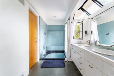 a bathroom with two sinks and a shower at Hillside Home with Outdoor Oasis and Pool in Sherman Oaks