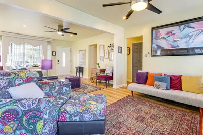 a living room with two couches and a flat screen tv at Stylish Home Near SoFi Stadium, LAX and Long Beach in Compton