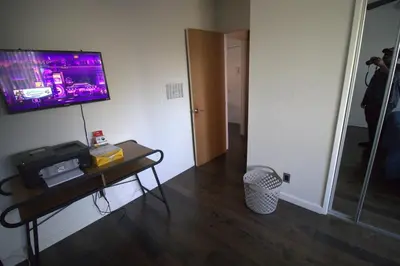 a room with a table with a tv on the wall at Charming 1-bedroom apartment in amazing Palms, Los Angeles with AC, Parking in Los Angeles