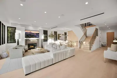 a living room with white furniture and a fireplace at Kraft Villa in Los Angeles