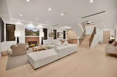 a living room with white furniture and a fireplace at Kraft Villa in Los Angeles