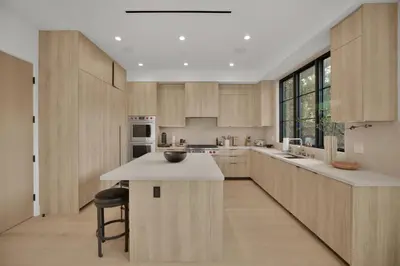 a kitchen with wooden cabinets and a white counter top at Kraft Villa in Los Angeles