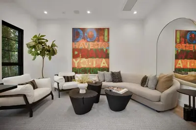 a living room with couches and tables and a painting at Kraft Villa in Los Angeles