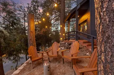 a group of chairs sitting on the porch of a house at Lumiere Cabin in Lake Arrowhead