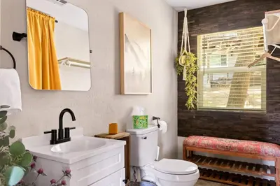 a bathroom with a white toilet and a sink at Lumiere Cabin in Lake Arrowhead