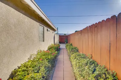a walkway in a garden next to a fence at Work and Play! Extended-Stay Studio in Simi Valley in Simi Valley