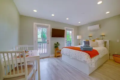 a bedroom with a bed and a table and a desk at Walk to Festival of Lights Cozy Couples Retreat in Riverside