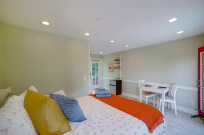 a bedroom with a bed and a table in it at Walk to Festival of Lights Cozy Couples Retreat in Riverside
