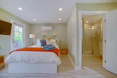 a bedroom with a bed and a walk in shower at Walk to Festival of Lights Cozy Couples Retreat in Riverside