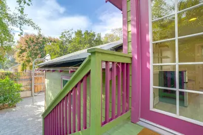 a pink and green house with a window at Walk to Festival of Lights Cozy Couples Retreat in Riverside